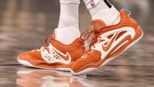View of Kevin Durant's orange and white Nike shoes.